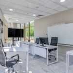 Spacious and bright modern office interior with sleek furniture, ideal for professional workspaces.